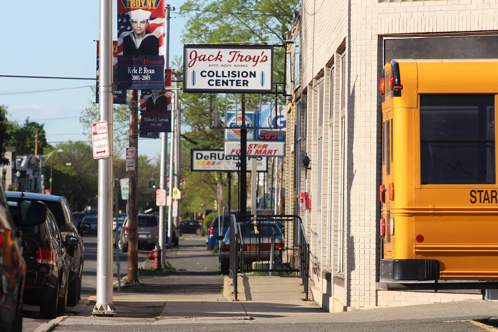 A street of car dealerships and repair shops on 5th Avenue in Troy, New York